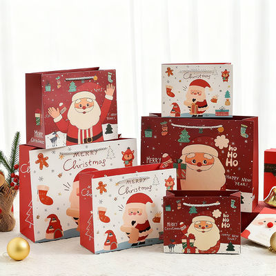 Tamaños personalizados Bolsas de Navidad Kraft Impresas Bolsas de regalo de lujo con mango de cinta